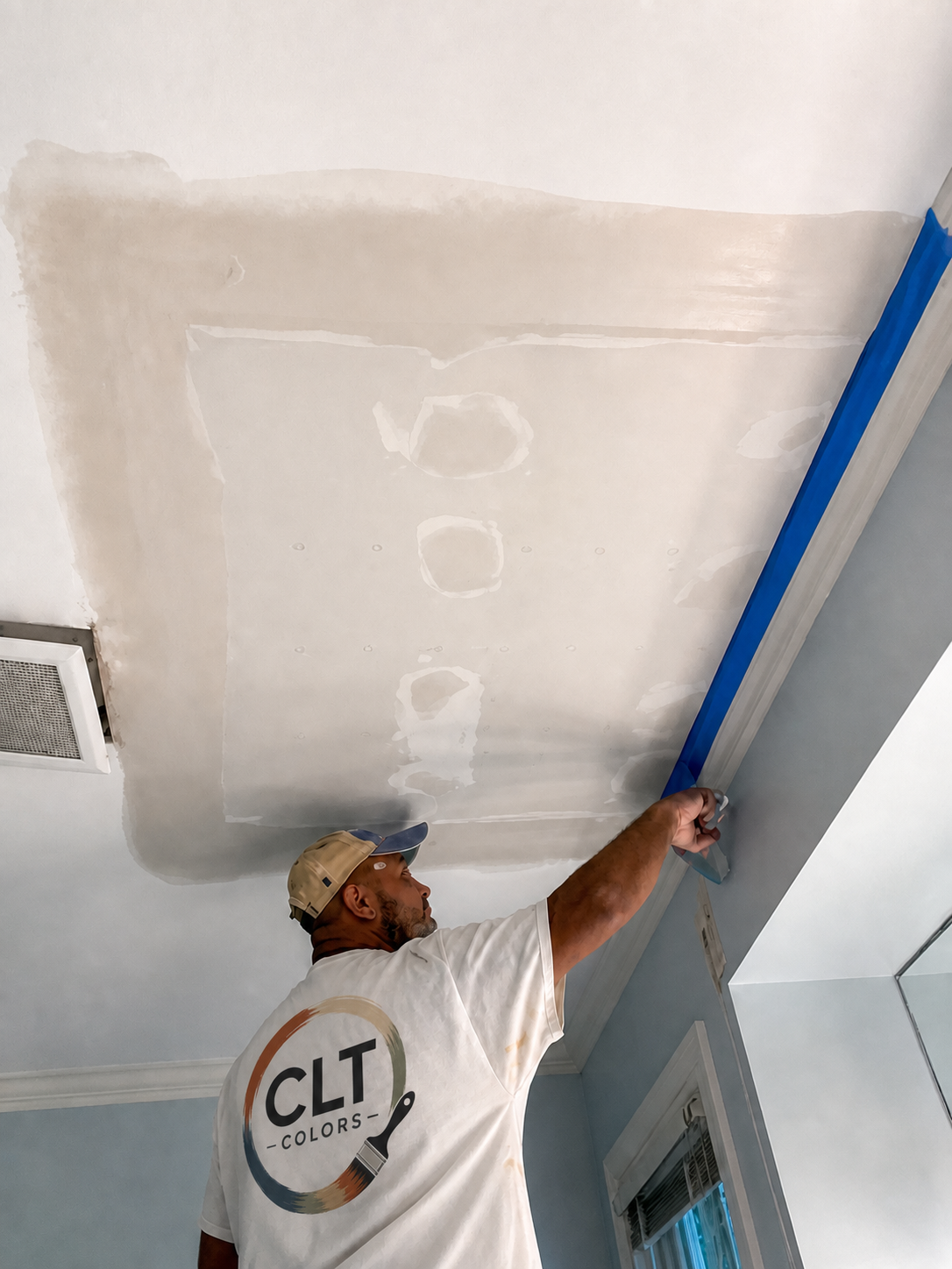 CLT Colors painter completing a ceiling repair